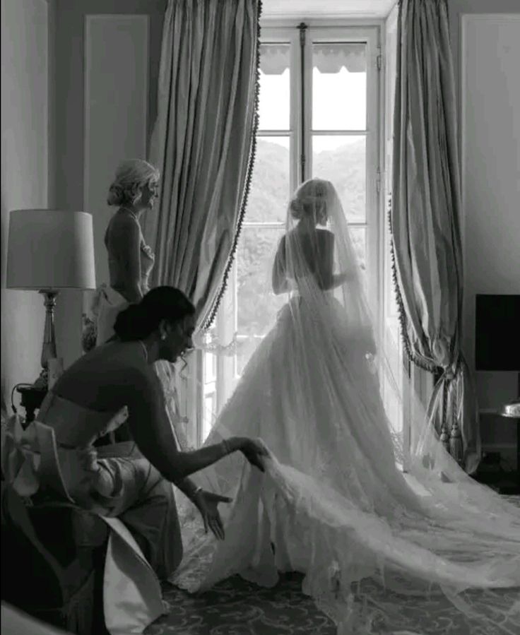 the bride is getting ready to walk down the aisle in her wedding dress and veil