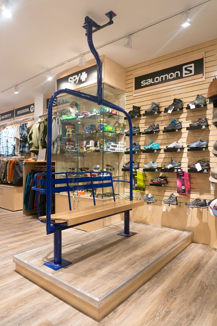 the inside of a shoe store with shoes on display