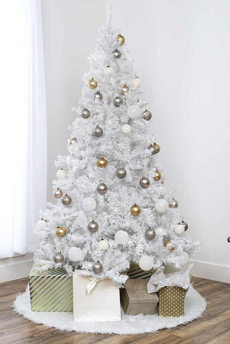 a white christmas tree with gold and silver ornaments