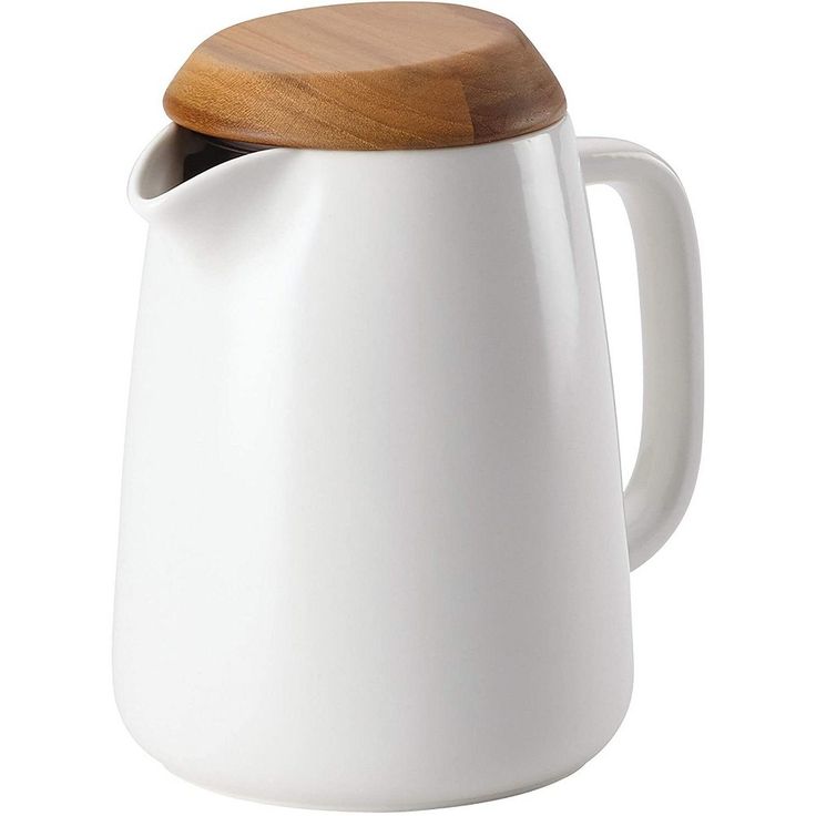 a white pitcher with a wooden lid on a white background, showing the top portion of the jug