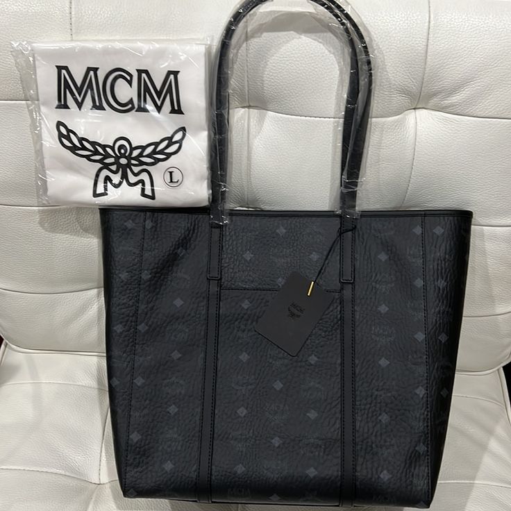 Brand New Black Mcm Tote With Mcm Cover Bag. Black Top Handle Shoulder Bag With Logo, Classic Black Shoulder Bag With Logo, High-end Black Bags For Daily Use, High-end Black Bag For Daily Use, High-end Black Bags With Branded Hardware, High-end Black Bag With Removable Pouch, High-end Black Shopping Bags, High-end Black Shoulder Bag, Modern Black Shoulder Bag With Logo