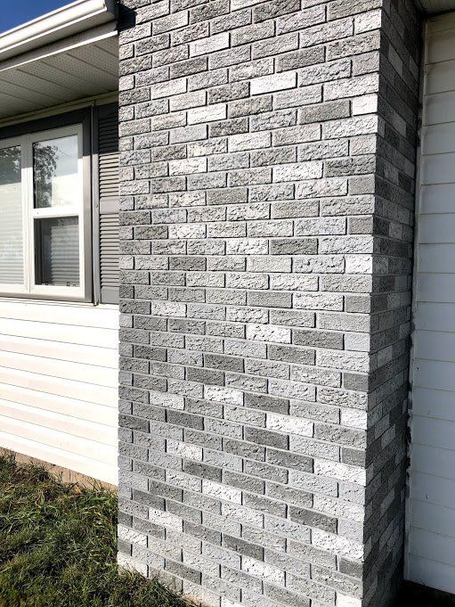 a brick wall in front of a house