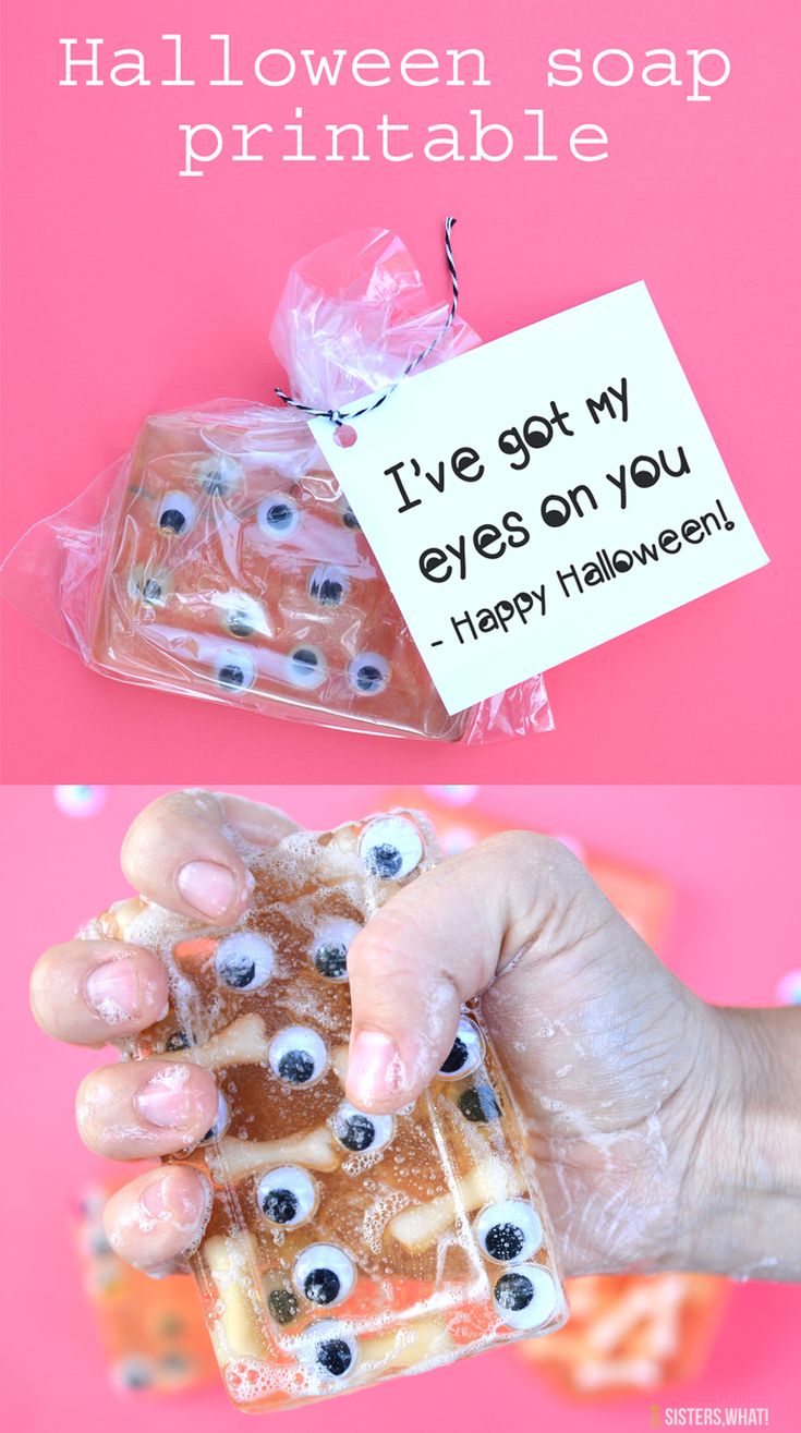 halloween soap with eyes on it is being held up by someone's hand and has a sign that says, i've got my eyes on you happy halloween