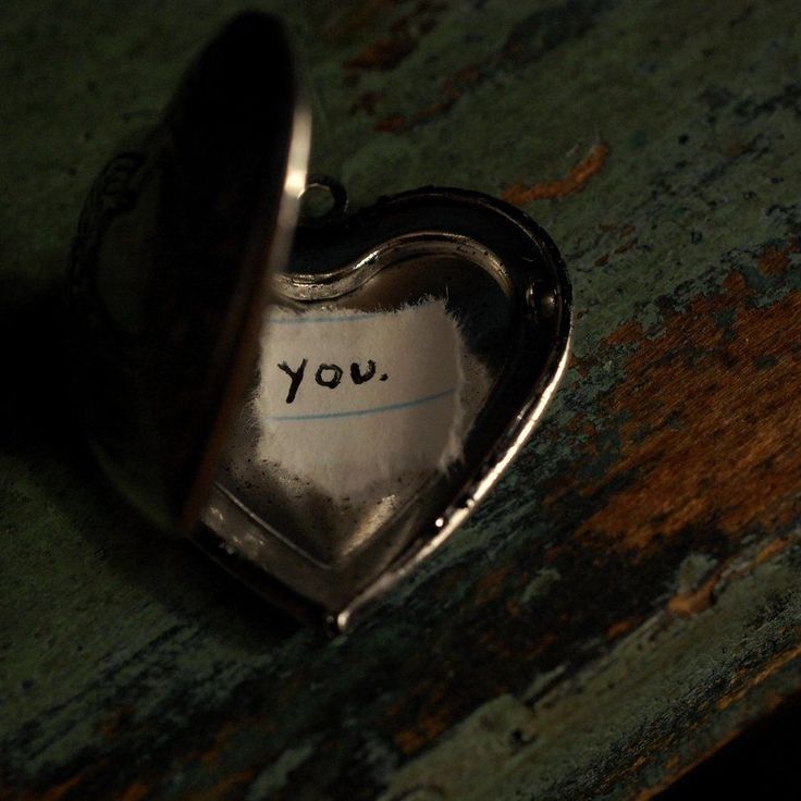 a heart shaped object with the word you written on it's side in silver