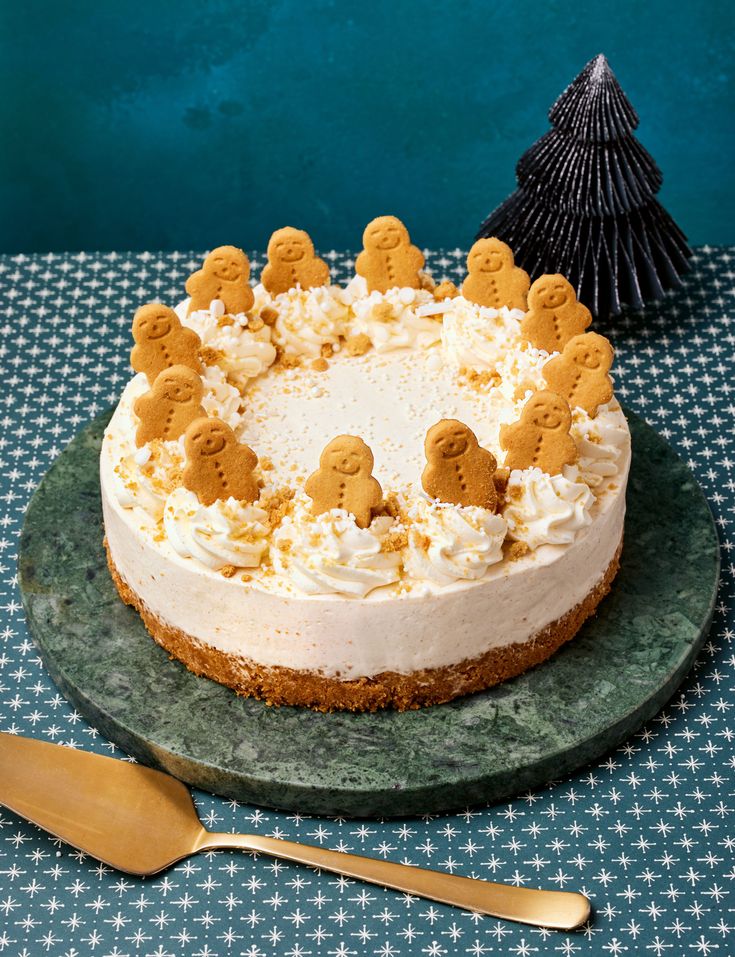 a cake with white frosting and cookies on top sitting on a plate next to a fork