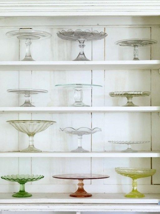 several glass dishes on shelves in a room