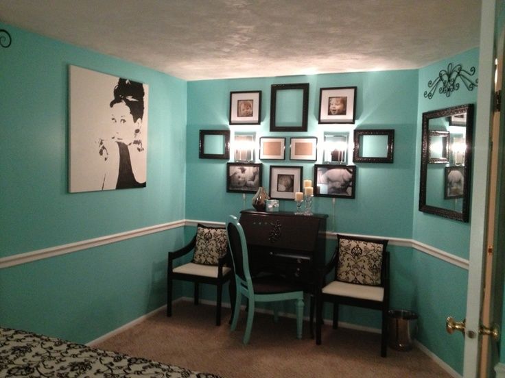 a room with blue walls and pictures on the wall