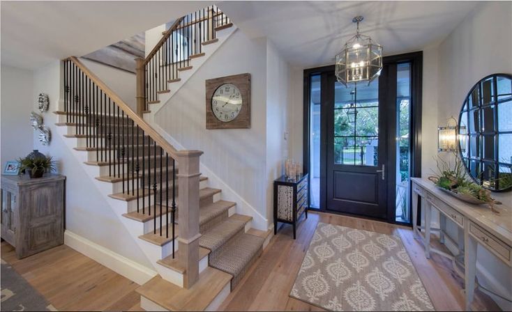 a staircase leading up to the second floor in a house with wood floors and glass doors