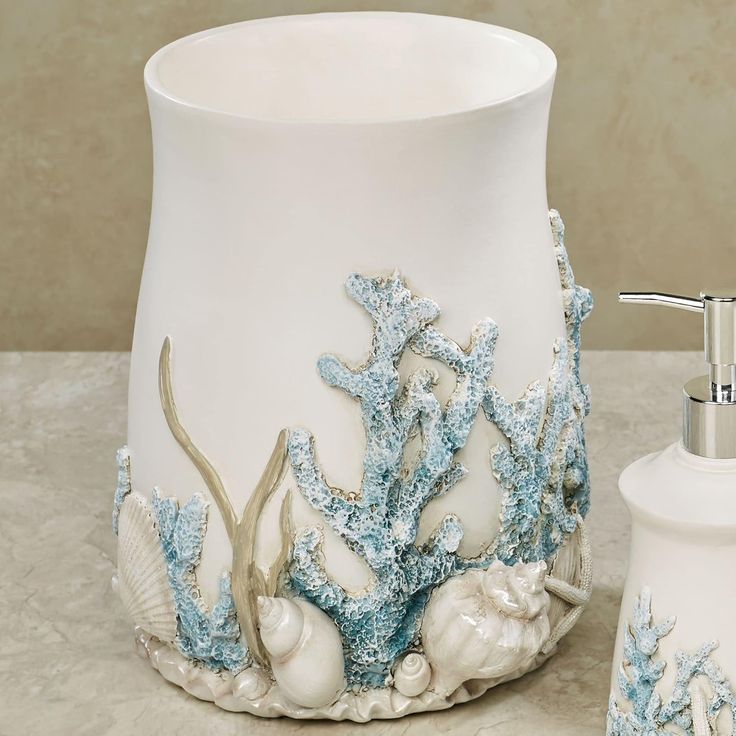 a white and blue bathroom set with soap dispenser