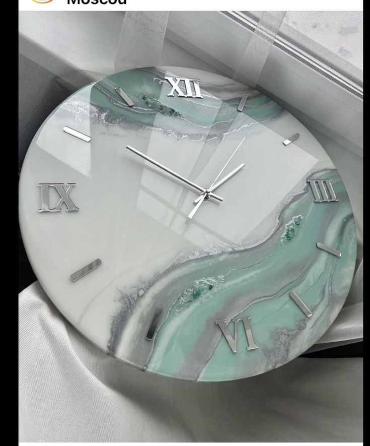 a marble clock with roman numerals on it