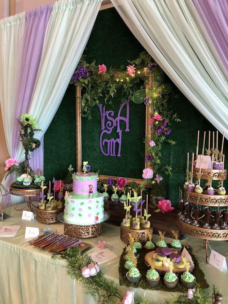 a table topped with lots of cakes and cupcakes