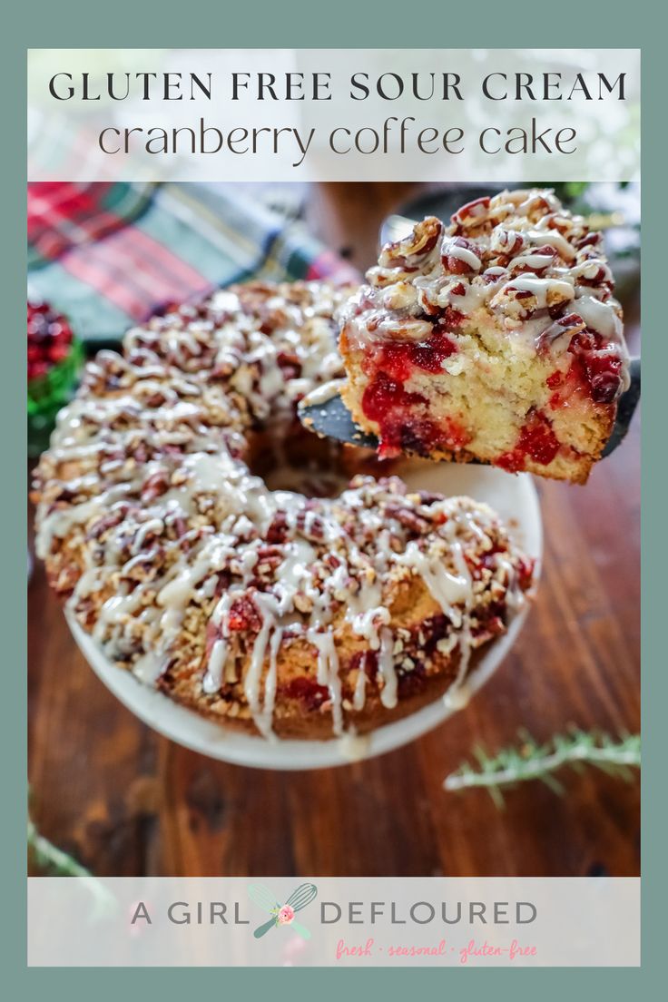 a cake with white frosting and cranberry coffee cake sitting on top of a wooden table