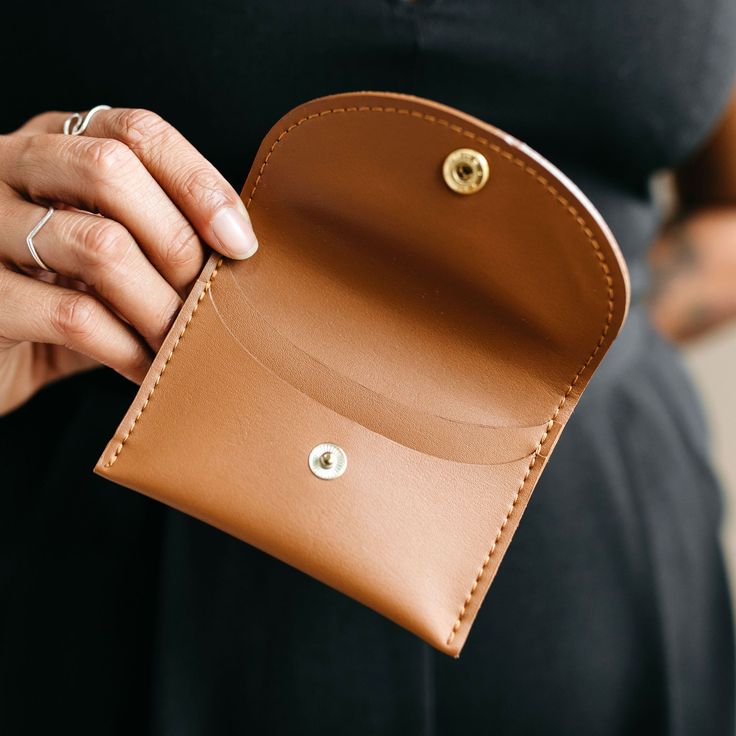 The Minimalist wallet is the perfect compact style that holds the right amount of essentials. It features two inside pockets and a snap closure. Made with vegan cactus leather. Dimensions: 4 3/8" x 3 1/4" Compact Coin Purse With Rfid Blocking, Minimalist Everyday Wallet With Coin Pocket, Compact Wallet With Interior Card Slots, Compact Wallet With Interior Card Slots For Everyday, Versatile Trifold Wallet With Card Slots As Gift, Versatile Compact Coin Purse For Everyday Use, Everyday Compact Versatile Coin Purse, Minimalist Wallet With Removable Pouch For Daily Use, Minimalist Bifold Coin Purse With Coin Pocket