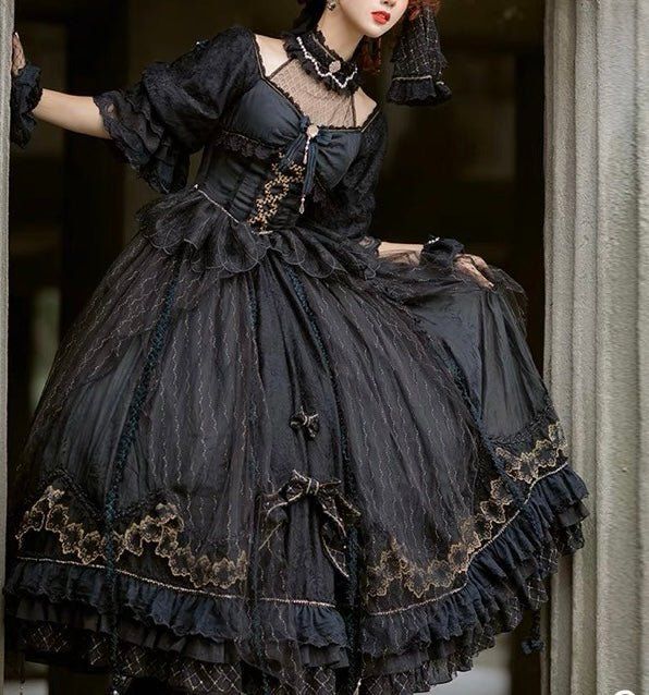 This Black Gothic Lolita Lace Wedding Dress With Corset Plus Size is a stunning alternative to a traditional white wedding dress. This dramatic and unique dress features a full-length black lace overlay with a corseted bodice and sweetheart neckline. The bodice is adorned with intricate silver embroidery, giving it a luxurious feel. The full-length skirt has a slight train and is finished off with a bow detail at the waist. The corset back allows for an adjustable fit to ensure you are comfortab Traditional White Wedding, Polka Dot Wedding Dress, Wedding Dress With Corset, Corset Plus Size, Rococo Dress, Dress With Corset, Silver Embroidery, Long Sleeve Wedding Dress Lace, Lace Wedding Dress Vintage