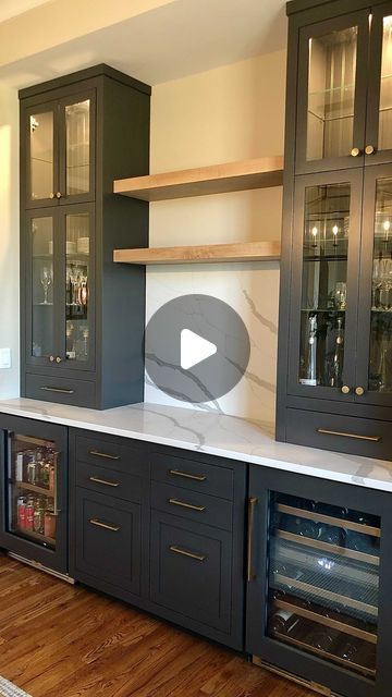 a kitchen with black cabinets and white counter tops