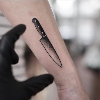 a knife tattoo on the arm