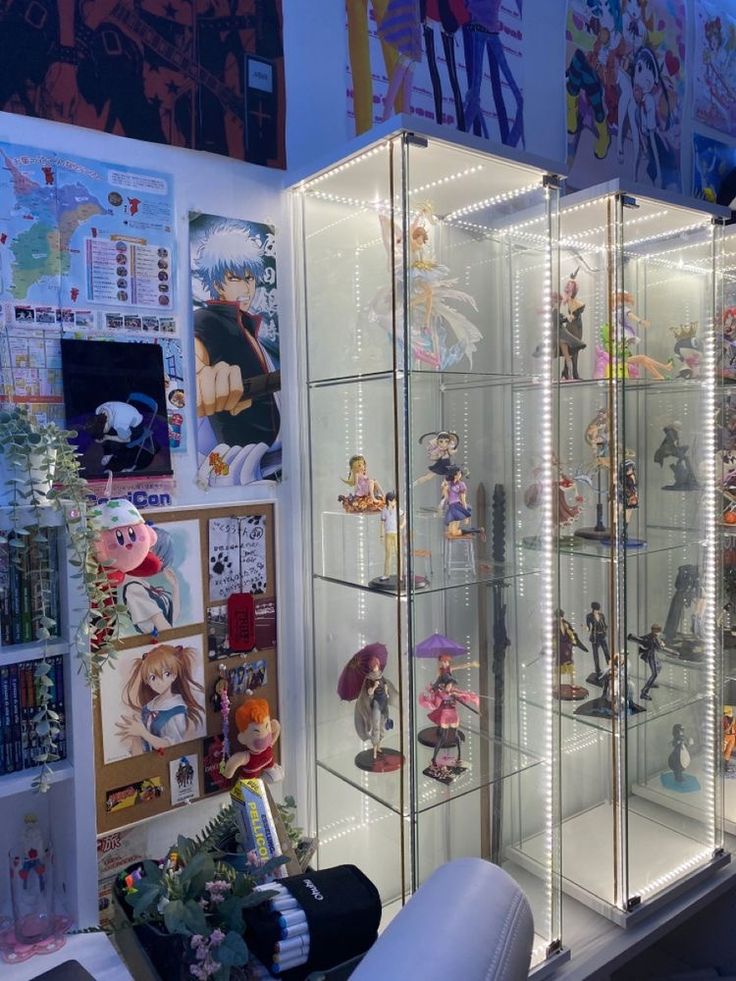 a display case filled with lots of anime figurines and pictures on the wall