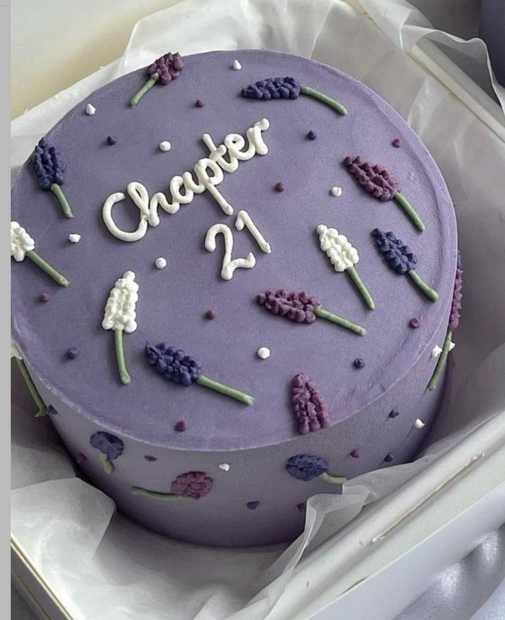 a purple cake sitting in a box on top of a table