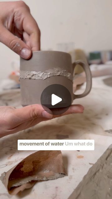 someone is holding a cup that has been made out of clay and then put together