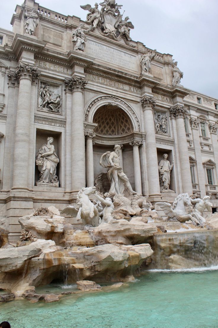 an ornate building with statues and fountains in front of the entrance to a water fountain