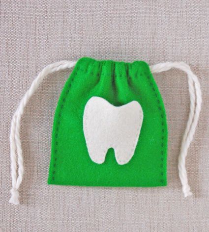 a green bag with a white tooth on it