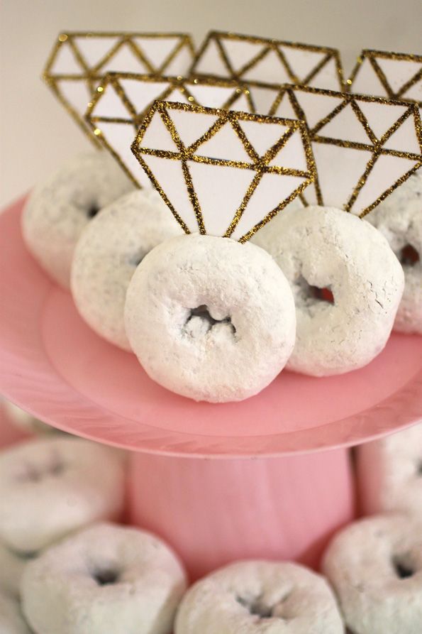 there are donuts on the pink cake stand