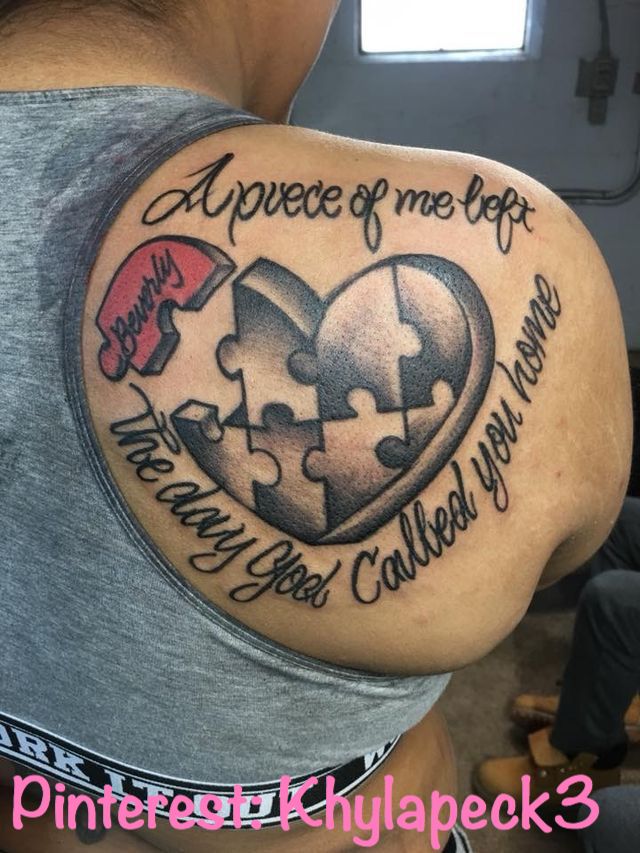 a man with a heart shaped puzzle piece tattoo on his arm and chest, which says i