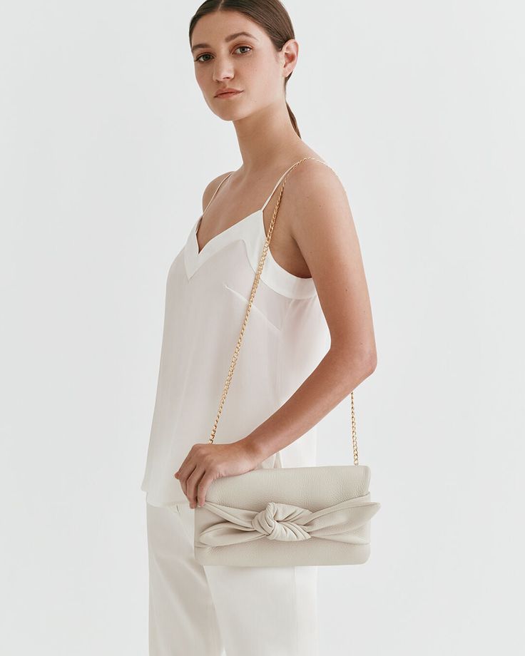 A fun finishing touch to your celebratory looks, made from luxurious Italian pebbled leather and lined in cotton twill, inspired by our bestselling Mini Bow Bag. Classic Neutral Bag For Formal Occasions, Elegant Leather Bags For Spring, Elegant Beige Evening Bag For Spring, Classic Neutral Formal Bag, Chic Formal Bag With Textured Leather, Elegant Spring Shoulder Bag In Soft Leather, Elegant Soft Leather Shoulder Bag For Spring, Elegant Soft Leather Bag In Neutral Color, Chic White Leather Evening Bag