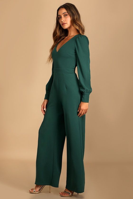 Special days call for a special piece like the Lulus Celebrating Romance Emerald Green Long Sleeve Wide-Leg Jumpsuit! Stretchy crepe knit shapes this jumpsuit that has a V-neckline and long sleeves with button cuffs and slightly puffy shoulders. A darted bodice tops a banded waist and flowy wide legs. Hidden back zipper/clasp. Fit: This garment fits true to size. Length: Floor length. Size medium measures 58.75" from shoulder to hem. Inseam: 30.75 Front Rise: 13.50 Bust: Great for any cup size. Fancy Romper Long Pants, Green Jumpsuit Outfit, Wedding Guest Jumpsuit, Green Wedding Guest Dresses, Jumpsuit Outfit Wedding, Emerald Green Jumpsuit, Jumpsuit Lulus, Jumpsuit Wedding Guest, Jumpsuit Winter