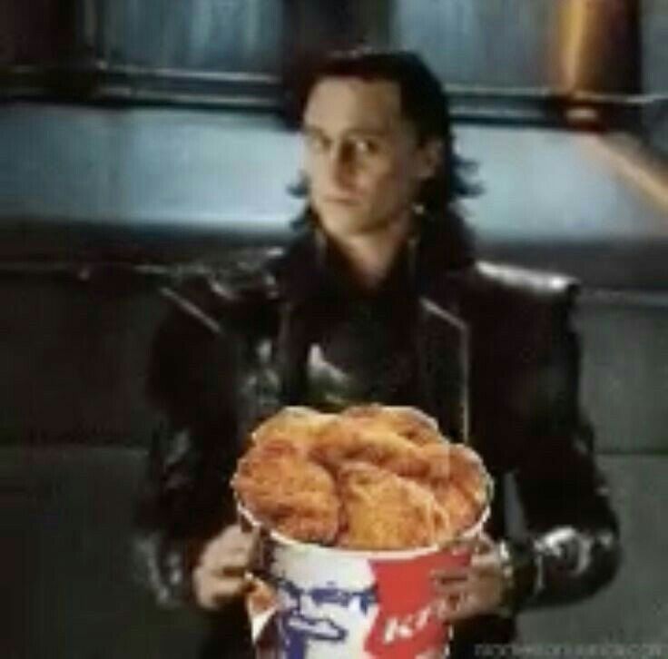 a man holding a bucket filled with donuts