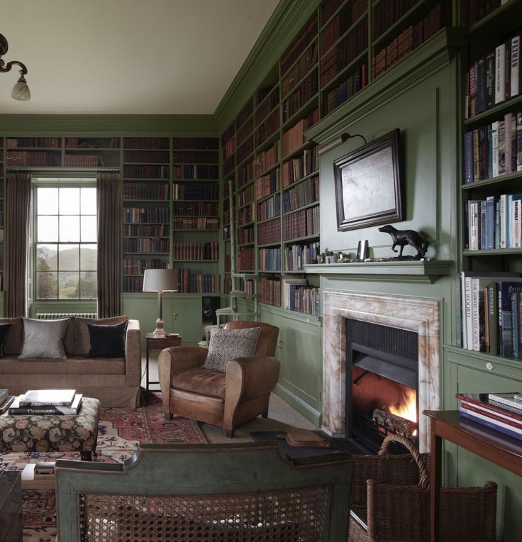 a living room filled with furniture and bookshelves covered in lots of bookcases