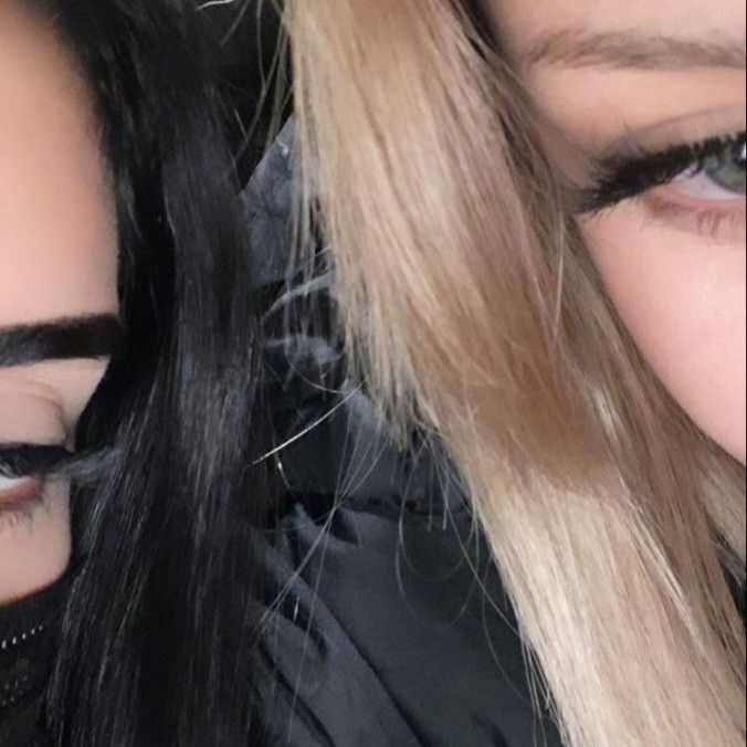 two women with long hair and black makeup