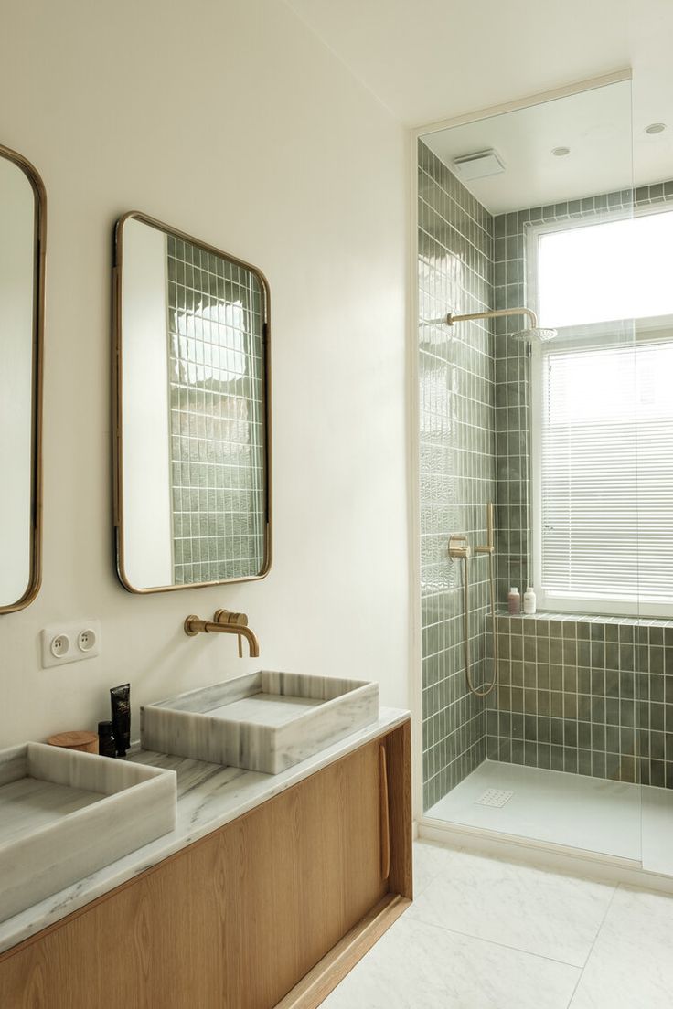 a bathroom with two sinks, mirrors and a bathtub in the middle of it