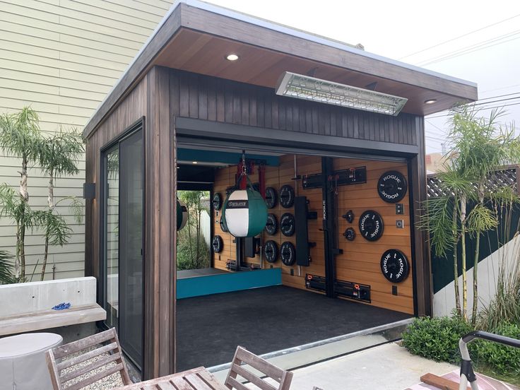 an outdoor garage with several items on the wall