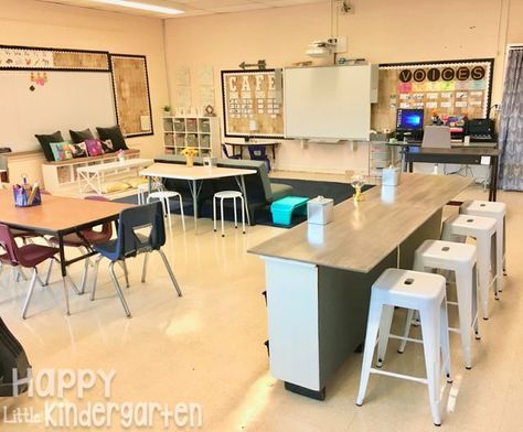 an empty classroom with desks, chairs and chalkboards on the wall in front of them