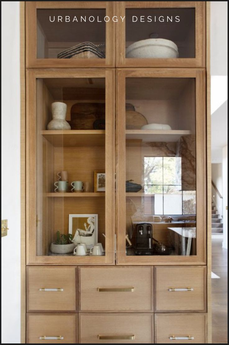 a wooden cabinet with glass doors and drawers