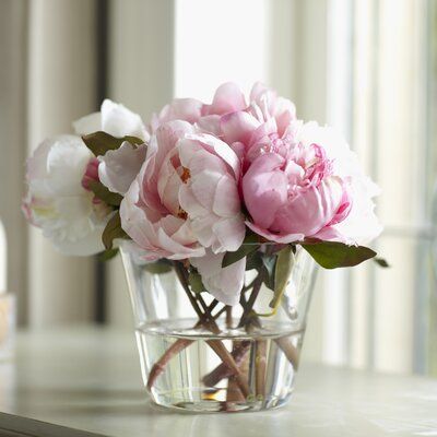 some pink flowers are in a glass vase