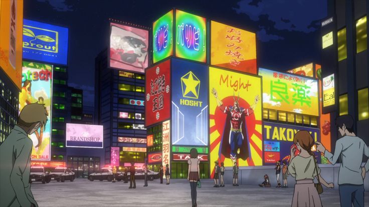 people are standing in the middle of a city at night