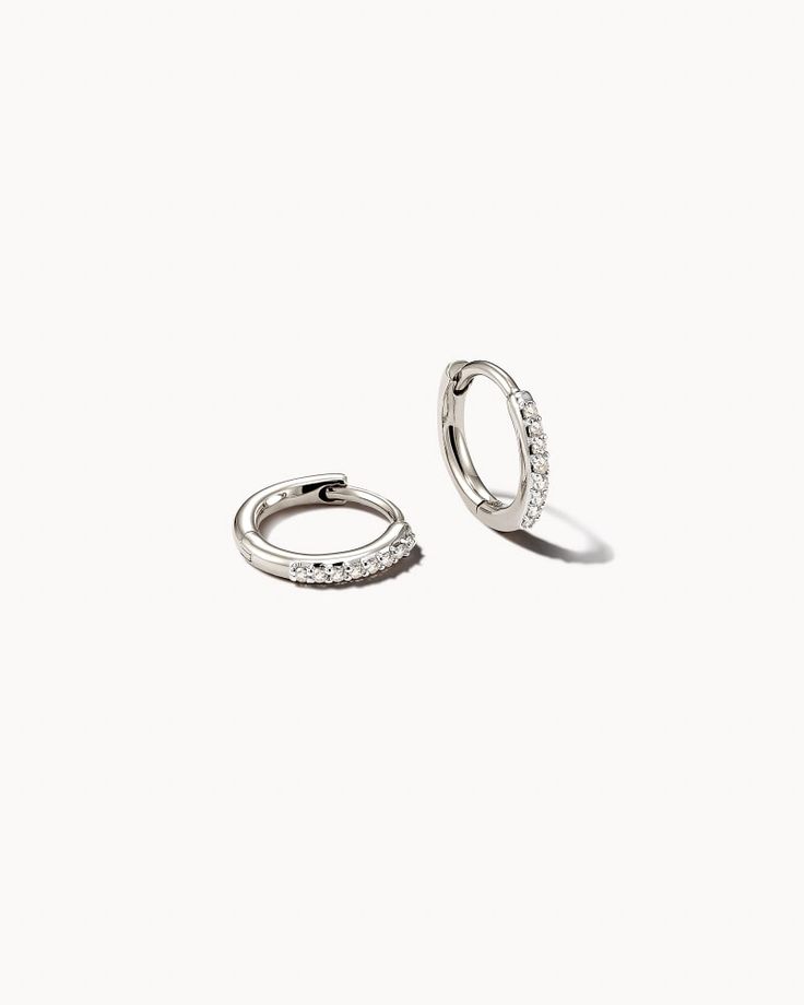 Heirloom both in quality and style, the Mila 14k White Gold Huggie Earrings in White Diamond will be a timeless addition to your wardrobe. Each diamond is hand selected and placed, bringing the sparkle to your everyday look and occasional outfits alike. 

 We have taken steps to ensure that, when applicable, our diamonds are conflict free by requiring our suppliers to comply with the Kimberley Process. 14k White Gold Huggie Earrings With Diamond Accents, White Gold 14k Huggie Earrings With Diamond Accents, Elegant White Huggie Earrings With Diamond Accents, Minimalist White Gold Huggie Earrings For Wedding, Luxury Round Sterling Silver Huggie Earrings, Luxury Silver Huggie Earrings With Single Cut Diamonds, Silver 14k Gold Earrings For Everyday Luxury, Luxury White Gold Huggie Earrings For Anniversary, Luxury White Gold Huggie Earrings For Wedding