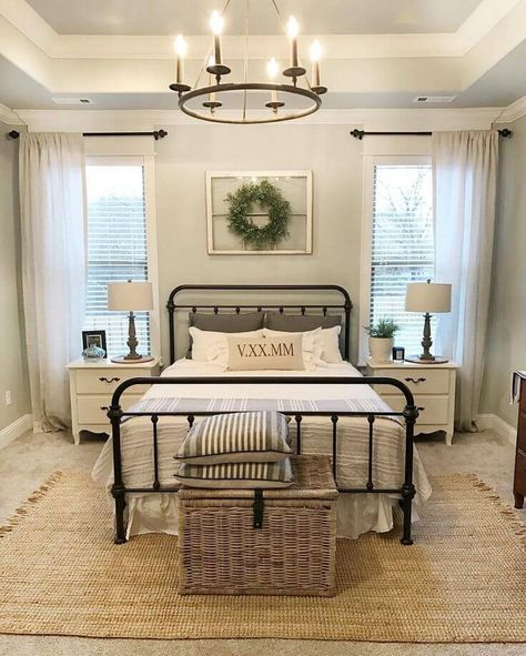 a bed room with a neatly made bed and a basket on the floor next to it