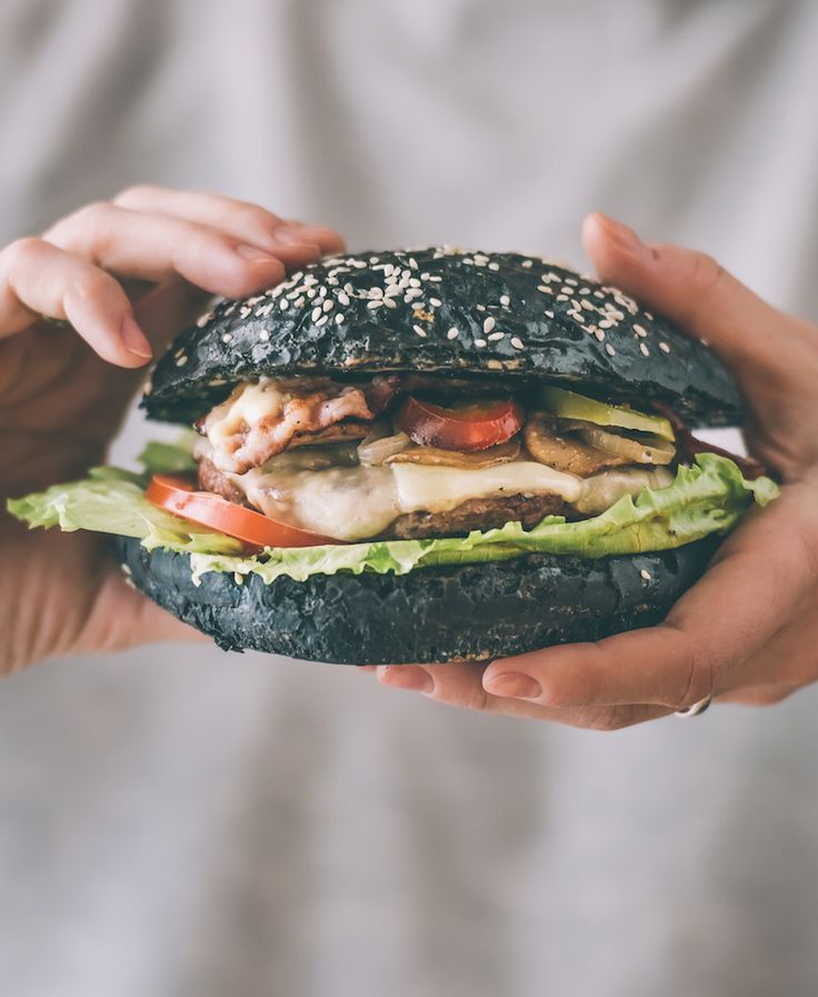 a person holding a sandwich in their hands