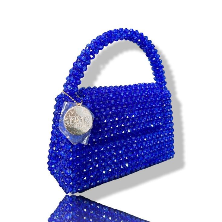 Artisan Beaded Handbag.Designed in NYC. Crafted with precision in the heart of Lagos, Nigeria.Elevate your style with our exquisite beaded handbags – a timeless accessory that seamlessly blends sophistication with versatility. Meticulously handcrafted, these bags are built to withstand the test of time. Whether paired with a cocktail dress, jeans and a tee, professional attire, or your favorite clubwear, our bead bags effortlessly complement any ensemble. Formal Beaded Shoulder Bag With Top Handle, Luxury Handmade Tote Evening Bag, Glamorous Beaded Bags As Gifts, Luxury Handmade Top Handle Evening Bag, Luxury Handmade Evening Bag With Top Handle, Formal Beaded Top Handle Shoulder Bag, Handmade Top Handle Evening Bag, Luxury Tote Evening Bag As Gift, Luxury Beaded Handheld Evening Bag