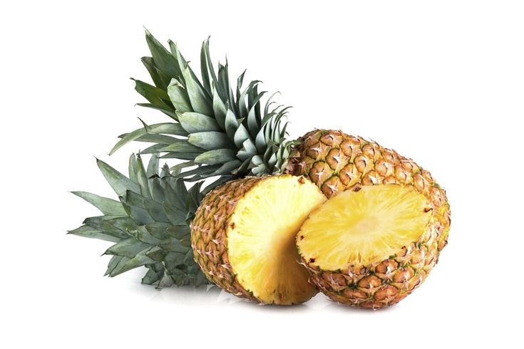 two pineapples with one cut in half and the other whole on a white background