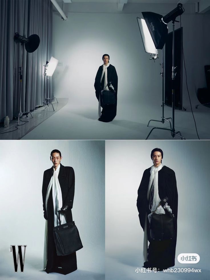 the man is standing in front of his camera and holding a bag while wearing a long black coat