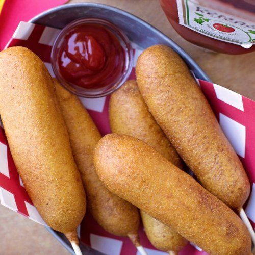 some fried food is in a basket with ketchup