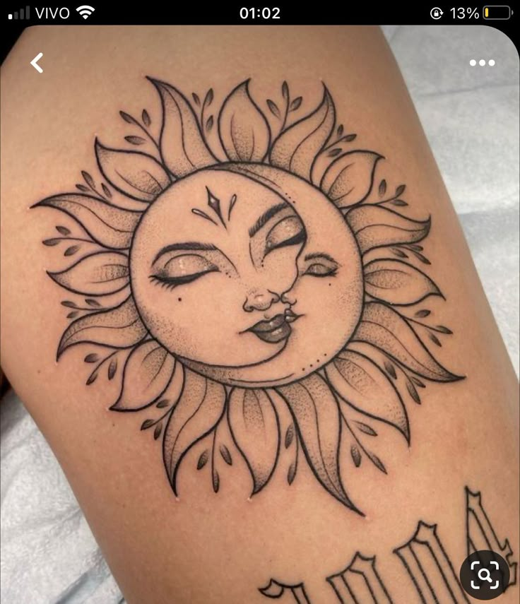 a sun tattoo on the back of a woman's thigh