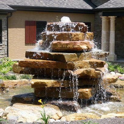 a water fountain in front of a house