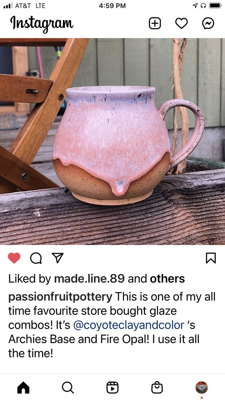 a pink vase sitting on top of a wooden table