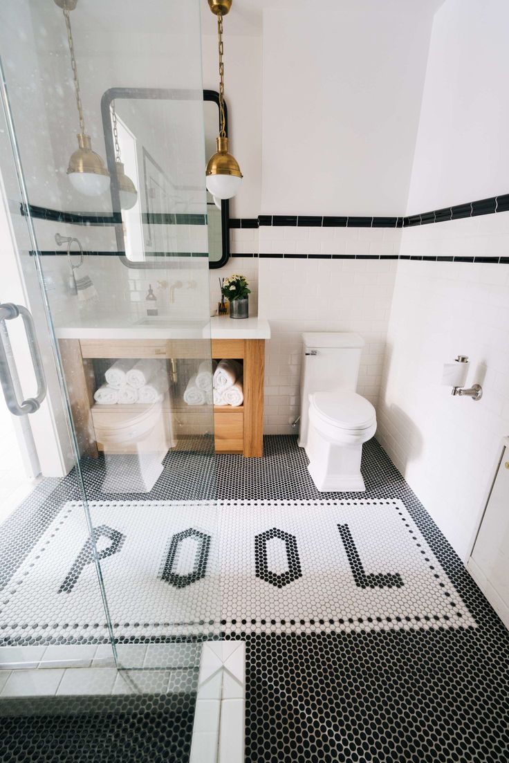 a bathroom with black and white tile flooring