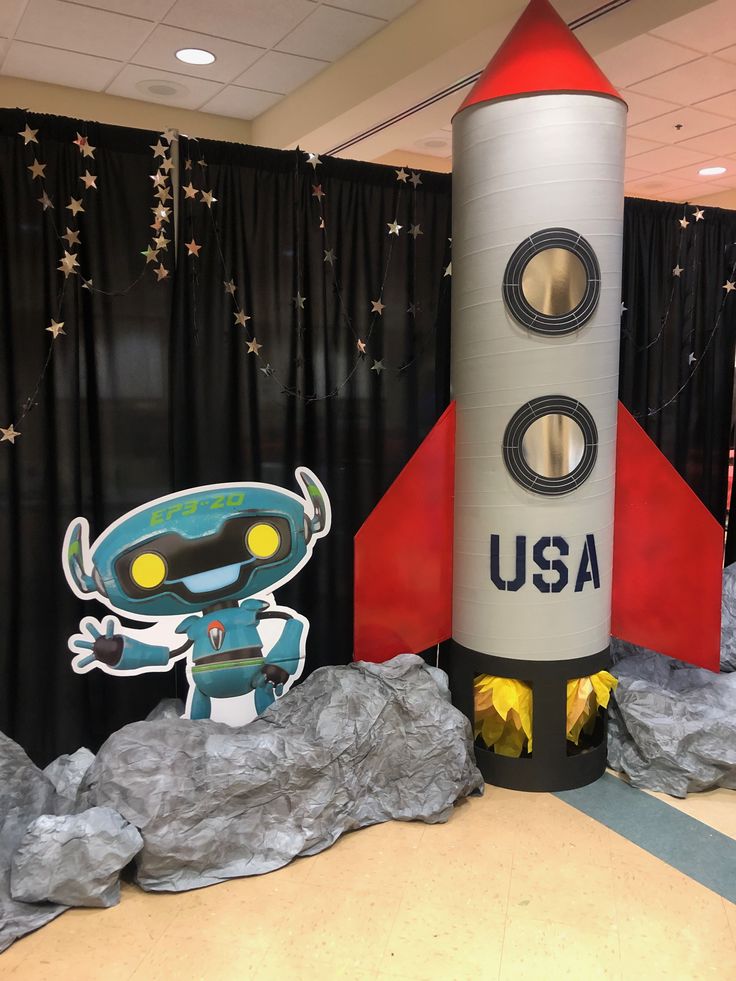 an inflatable rocket with a sticker on the side and stars around it